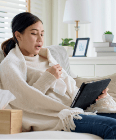 Woman having a virtual healthcare visit on a table