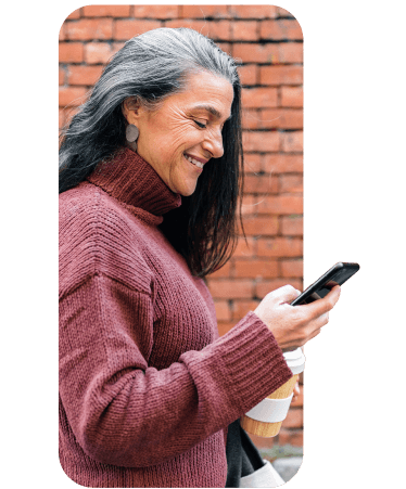 Smiling senior man using his smartphone outdoors, exploring Medicare options