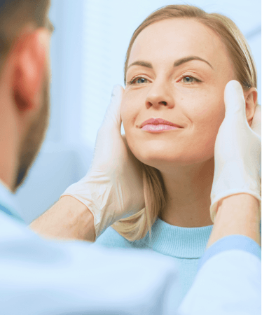 Female patient receiving a facial assessment from a healthcare professional