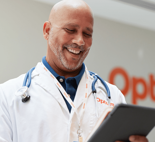 Woman using the Optum WA MyChart app on her smartphone for healthcare management