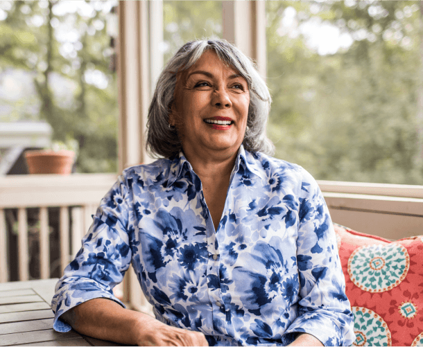 Smiling senior woman sitting on a porch