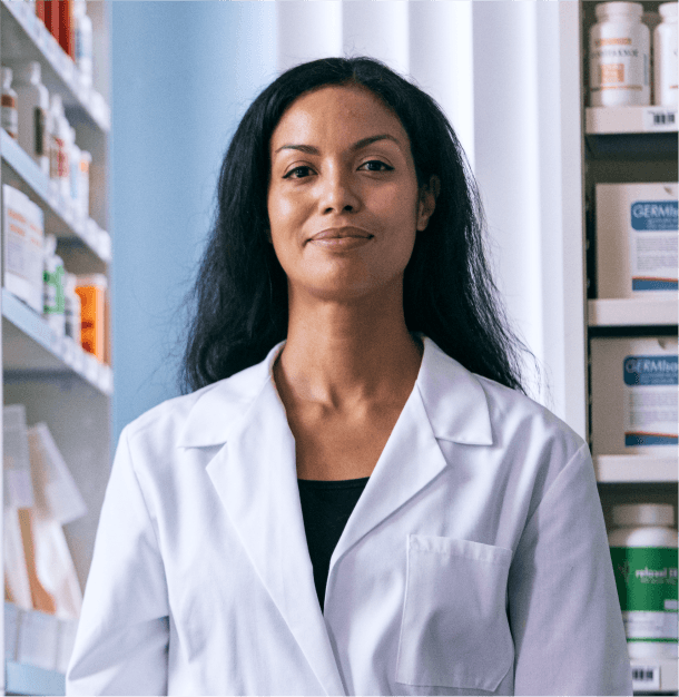 Pharmacist in a white coat standing in a pharmacy at Optum WA
